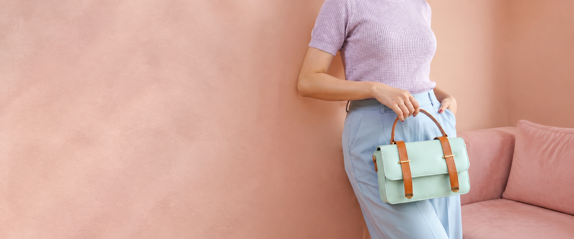 Mint-green Melora handbag with cognac straps, styled with lavender knitwear and powder-blue trousers against rose plaster.
